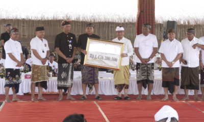 Bupati Badung I Wayan Adi Arnawa menyerahkan dana hibah saat menghadiri Karya Agung Pitra Yadnya Ngaben Massal Desa Adat Jimbaran, Selasa (1/9).