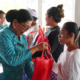 Ketua TP PKK Provinsi Bali Ny. Putri Koster menyerahkan bantuan dalam Aksi Sosial Bergerak dan Berbagi di Desa Pengotan, Bangli.